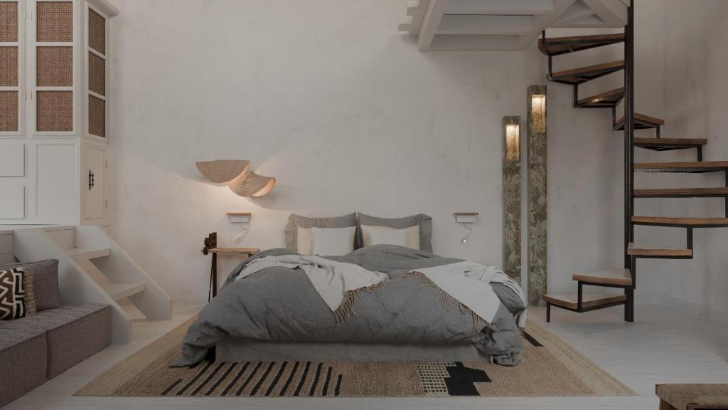 a bedroom with a bed and a staircase in it at Aelia mini villa in Lindos
