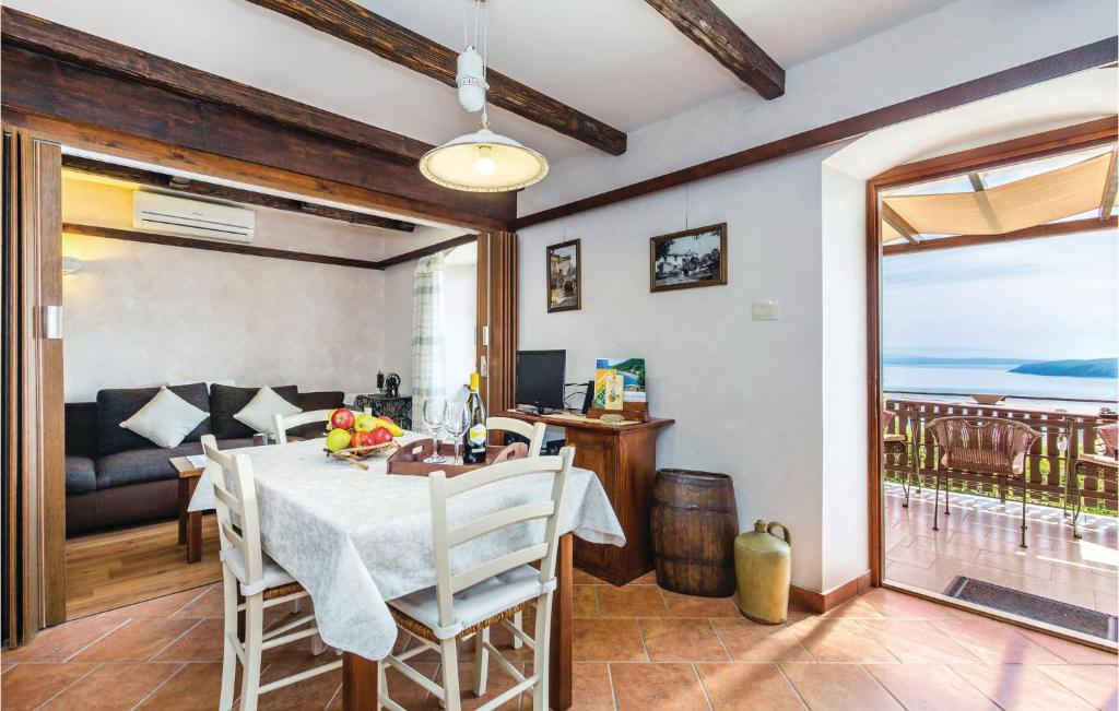 kuchnia i jadalnia ze stołem i krzesłami w obiekcie 1 Bedroom Cozy Home In Moscenicka Draga w mieście Mošćenička Draga