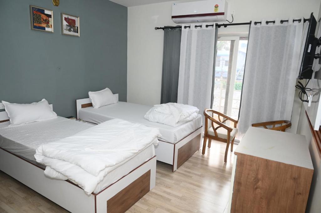 Postel nebo postele na pokoji v ubytování shangrila stay