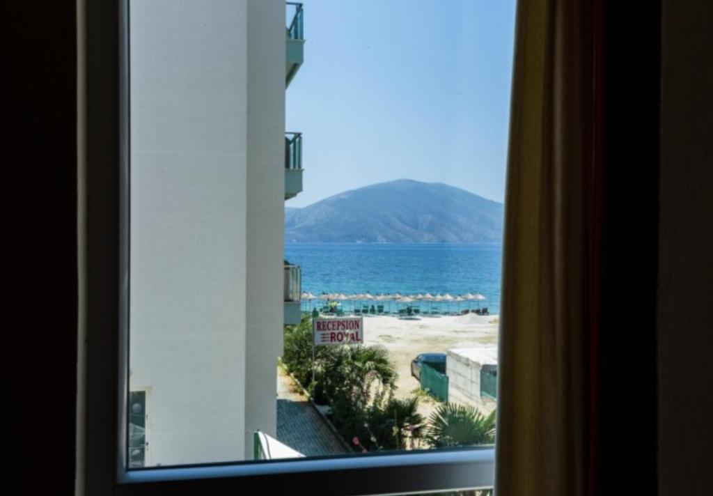 a view of the ocean from a hotel room window at Hotel Garden in Vlorë
