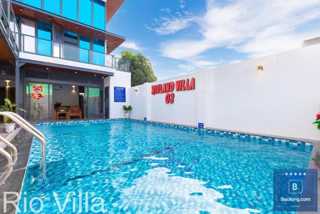 a swimming pool in front of a building at Rio Villa 3 - Cách Biển 100 Met - Free Bida - Karaoke - 6 Phòng Ngủ - Gần Biển Đi Bộ in Vung Tau