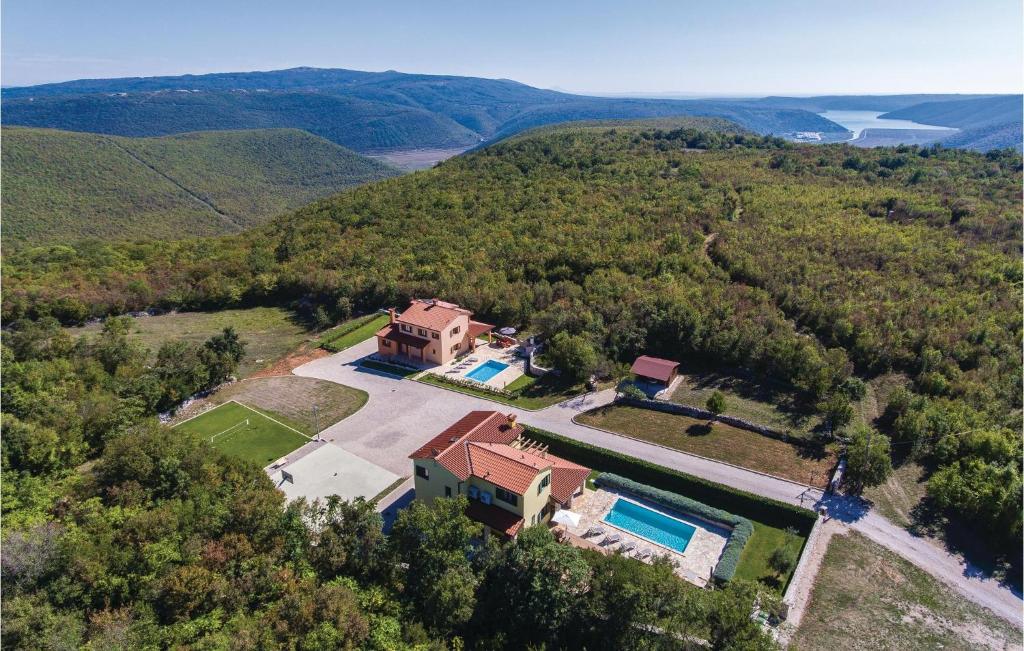 an aerial view of a house in the hills at Holiday Home Kunj Croatia in Kunj