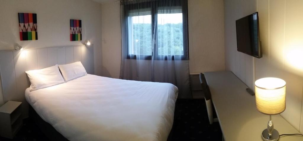 Postel nebo postele na pokoji v ubytování Hôtel Le Forestia
