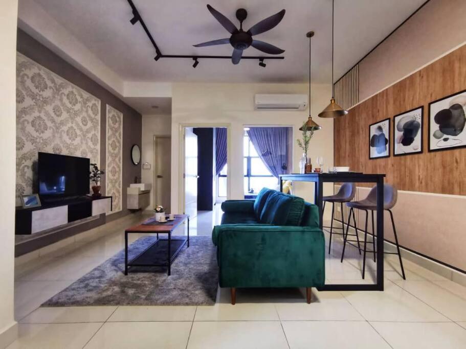 a living room with a green couch and a table at Arte Mont Kiara Studio,Kuala Lumpur in Kuala Lumpur