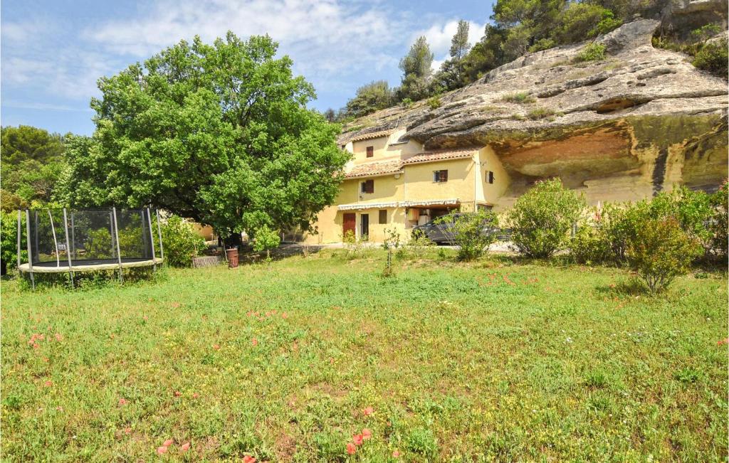 a house in the middle of a grass field at Amazing Home In Beaumettes in Beaumettes