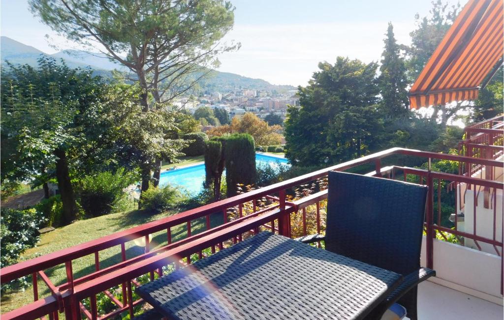 a balcony with a bench and a swimming pool at Villa Castiglioni 031 in Luino
