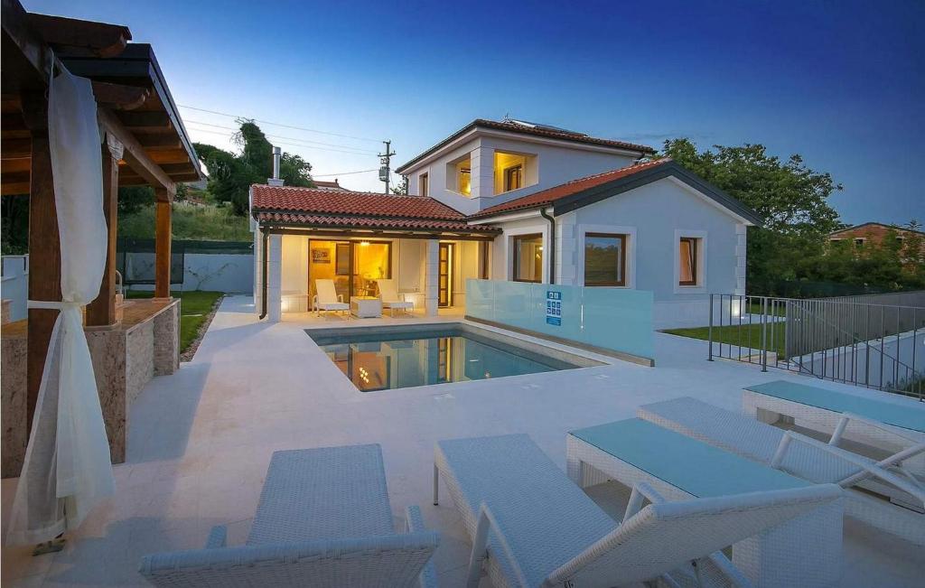 a villa with a swimming pool in front of a house at Villa Gloria Vita in Brtonigla