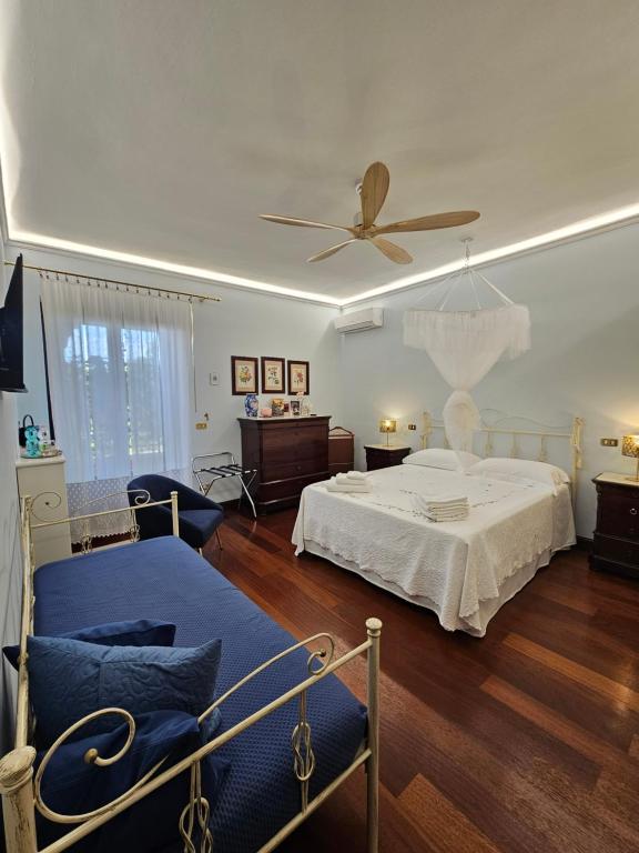 a bedroom with a bed and a ceiling fan at A Casa del Farmacista in Casarano