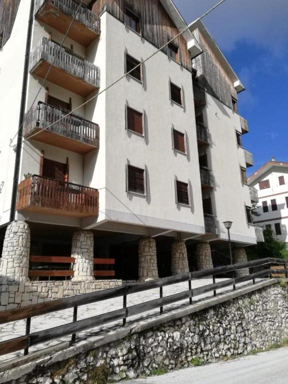 a large white building with balconies on the side of it at Casa Ena in Roccaraso