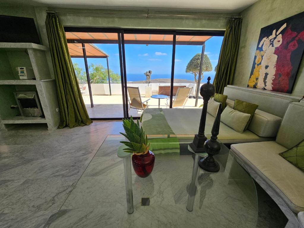 a living room with a couch and a glass table at La Ranita 2 EMPIREO in La Asomada