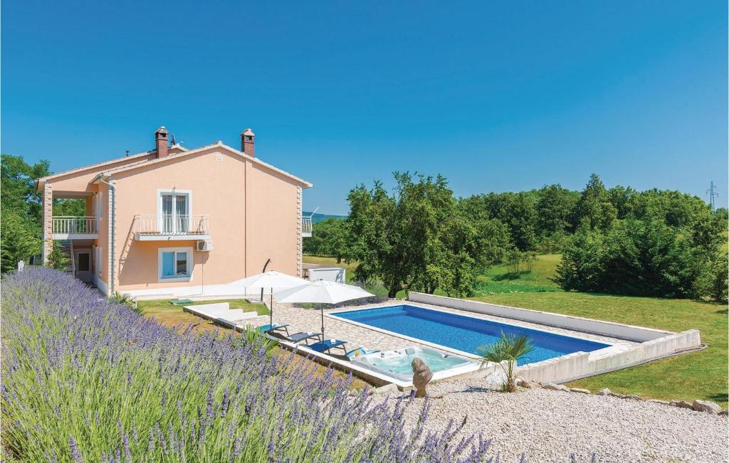 a villa with a swimming pool in front of a house at Beautiful Home In Nedescina in Nedeščina