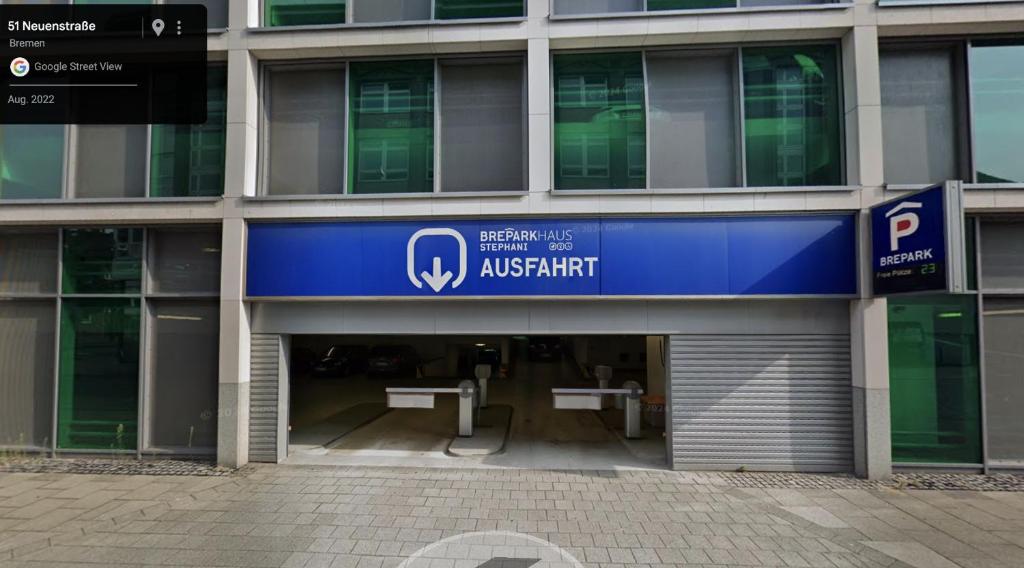 an entrance to an apartment building with a blue sign at Schlachte-Studio No5 in Bremen