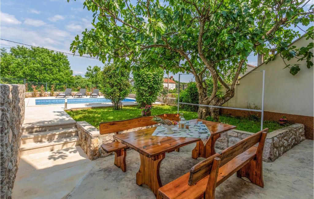 a wooden table and two benches on a patio at Amazing Home In Polje With Wifi in Polje