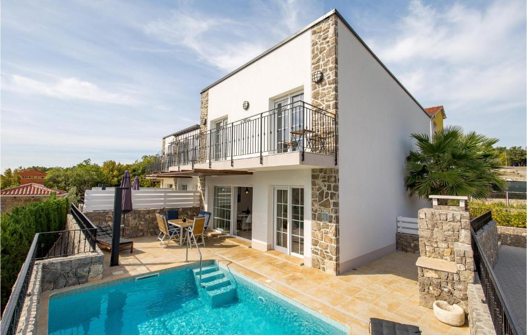 a villa with a swimming pool and a house at 3 Bedroom Nice Home In Kornic in Kornić