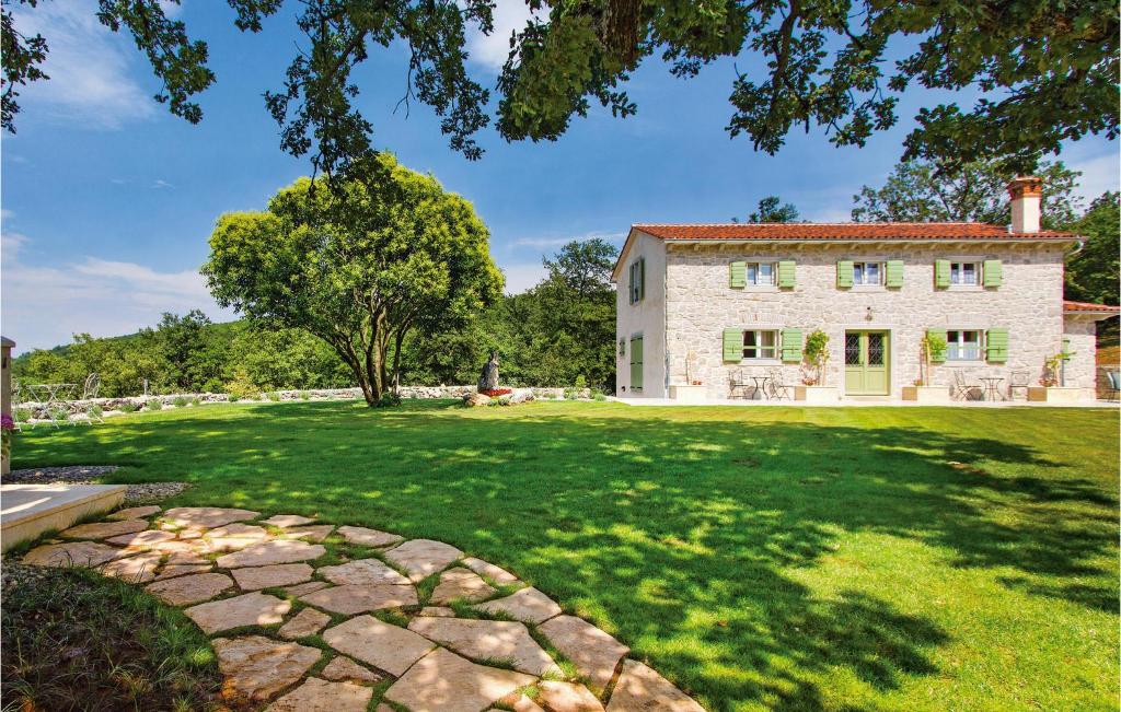 an exterior view of a house with a large yard at Awesome Home In Labin With Sauna in Labin