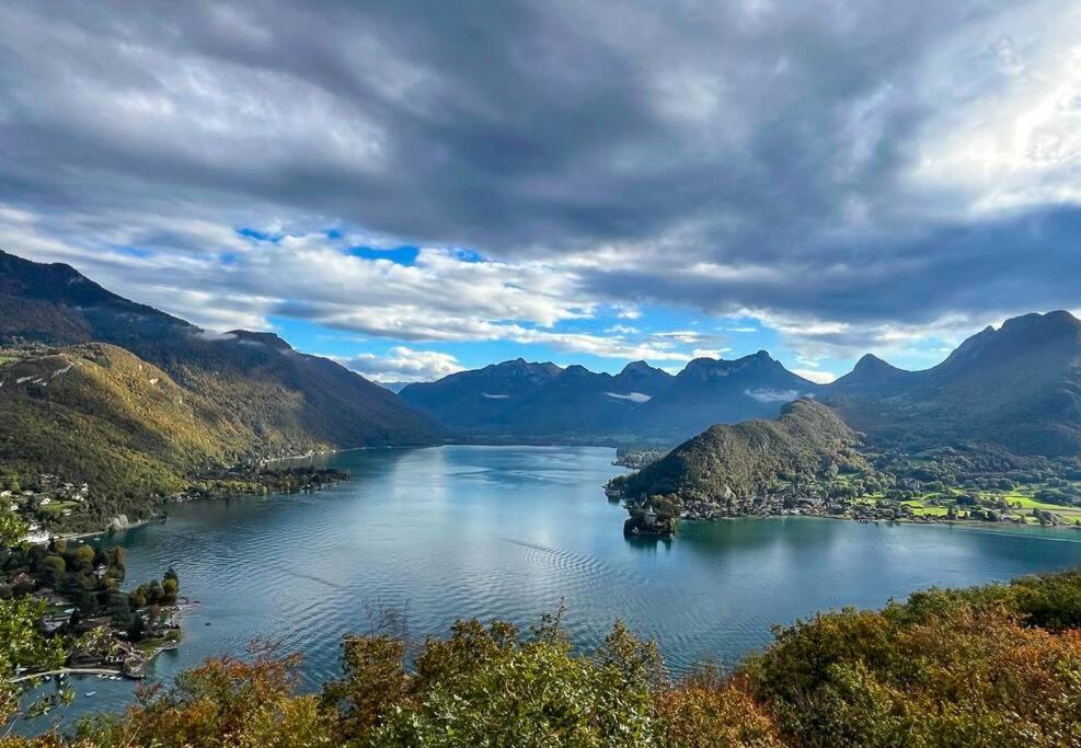 a view of a lake in a valley with mountains at L'Aquarium, parking gratuit, garage moto et vélo in Talloires