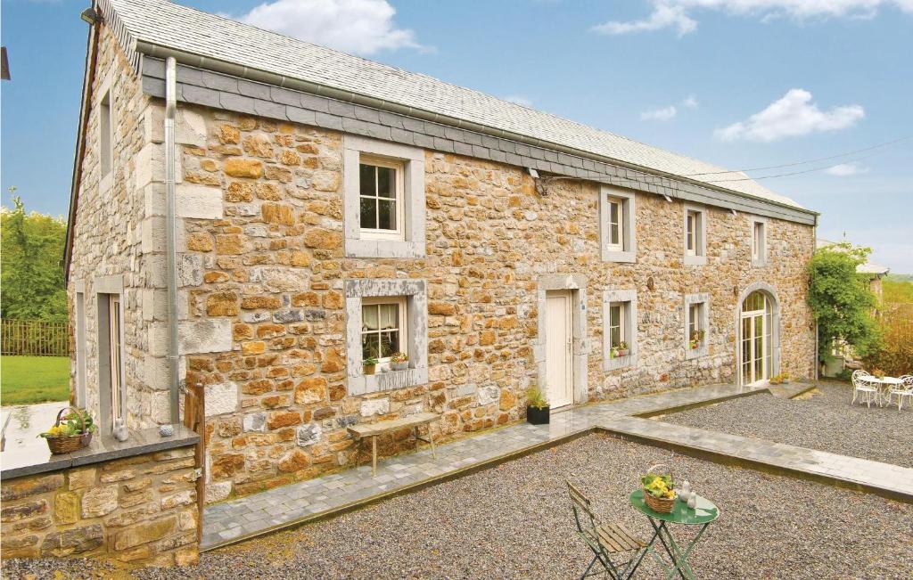an exterior view of a stone house with a courtyard at Dell'arte in Morville
