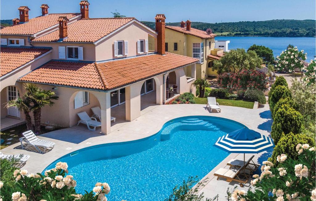 an image of a house with a swimming pool at Holiday Home Pomer Ii in Pula