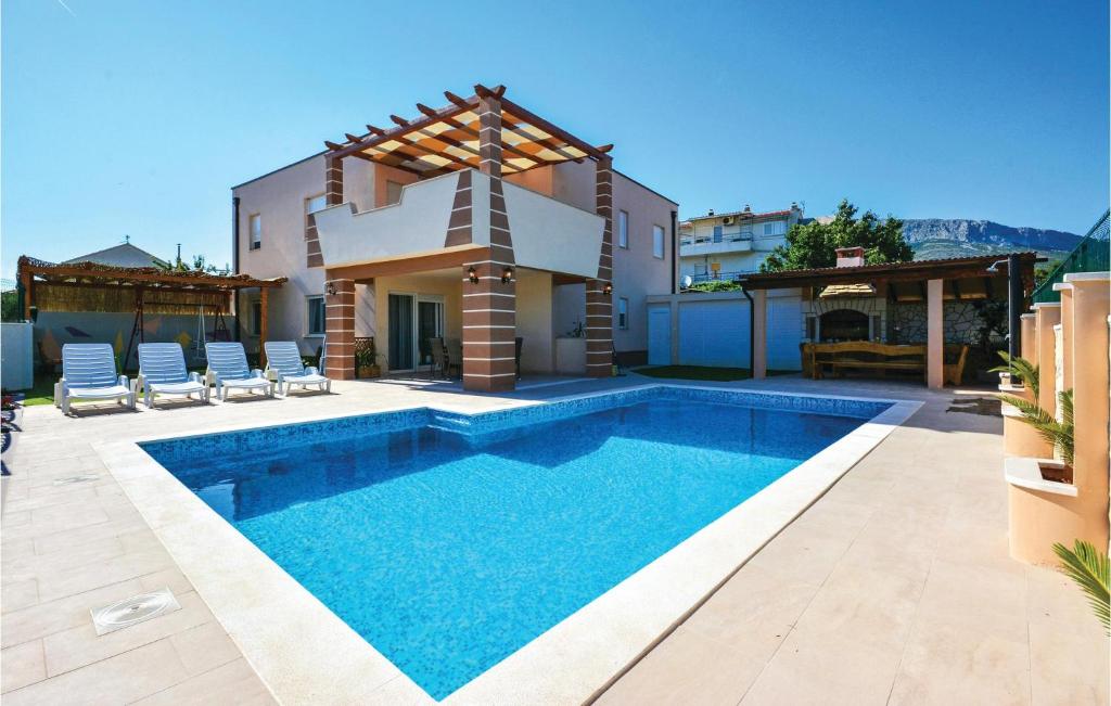 a swimming pool in front of a house at Gorgeous Home In Solin in Solin