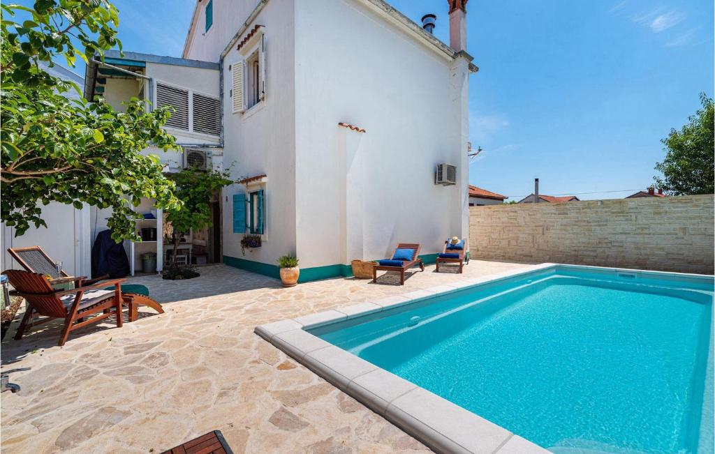 a swimming pool in the backyard of a house at Villa La Maison Adriatique in Zadar
