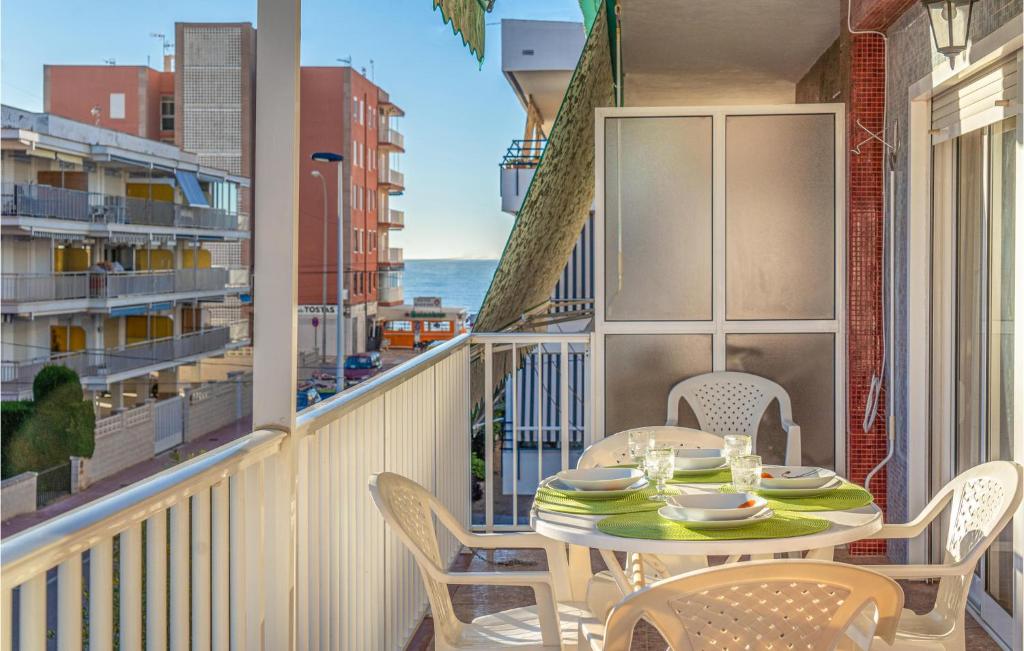 a balcony with a table and chairs and the ocean at Awesome Apartment In Santa Pola in Santa Pola