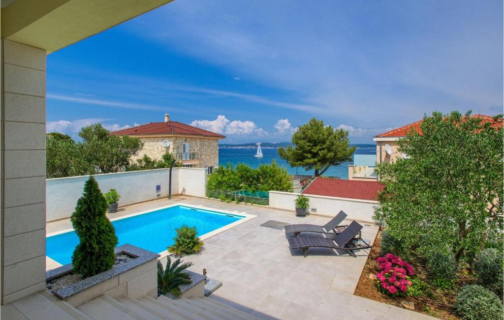 a backyard with a swimming pool and a house at Villa Tatijana in Zadar