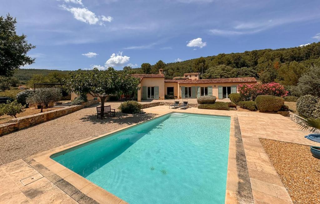 a swimming pool in front of a house at Cozy Home In Salernes With Wifi in Salernes