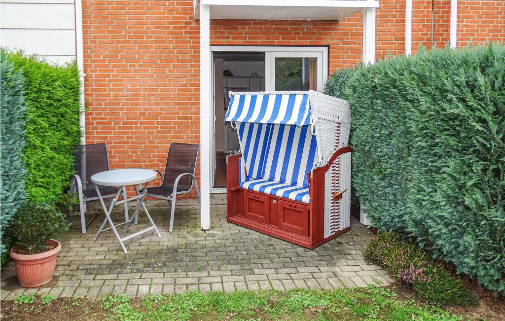 a patio with a chair and a table next to a building at 1 Bedroom Lovely Apartment In Kirchdorf in Kirchdorf