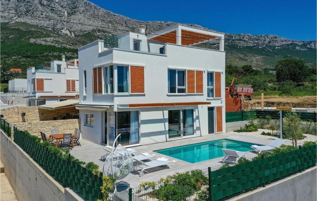 a large white house with a swimming pool at Amazing Home In Kastel Gomilica in Kaštela