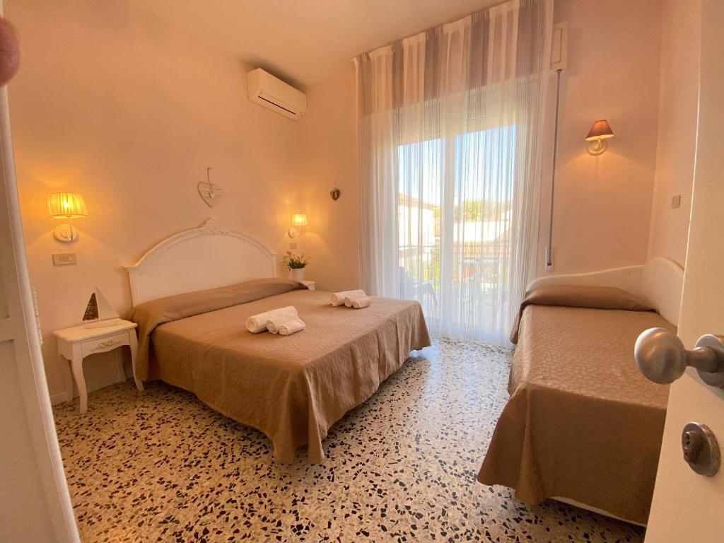 Postel nebo postele na pokoji v ubytování Hotel Smart Cervia B&B