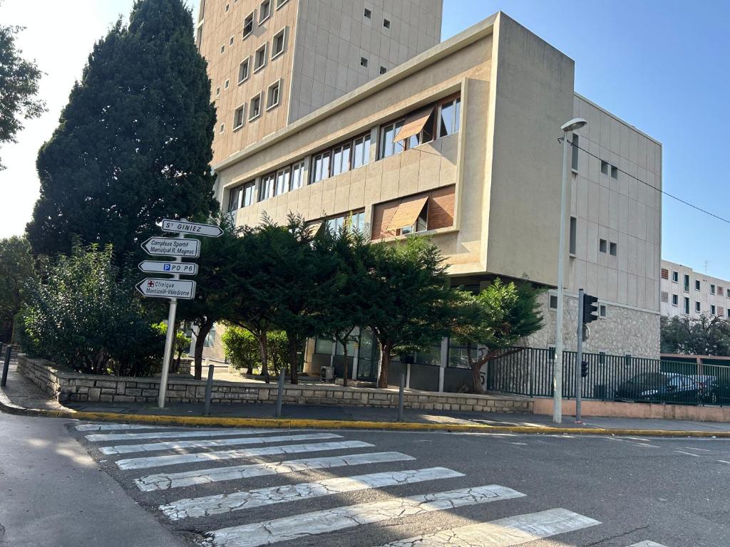une rue vide avec un bâtiment comportant des panneaux de signalisation dans l'établissement Appartement Standing, Parkings devant le Velodrome, à Marseille