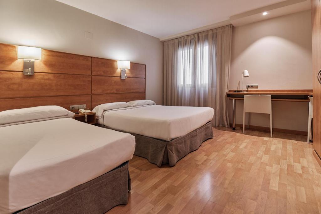 Postel nebo postele na pokoji v ubytování Hotel Avenida