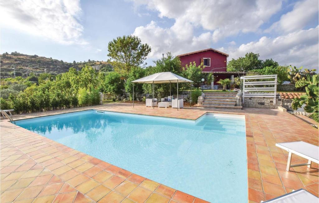 a swimming pool in a yard with a house at 4 Bedroom Stunning Home In Giarratana in Giarratana