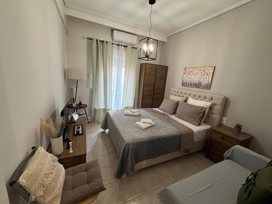 a bedroom with a large bed and a couch at Evann's sweet home in Larisa