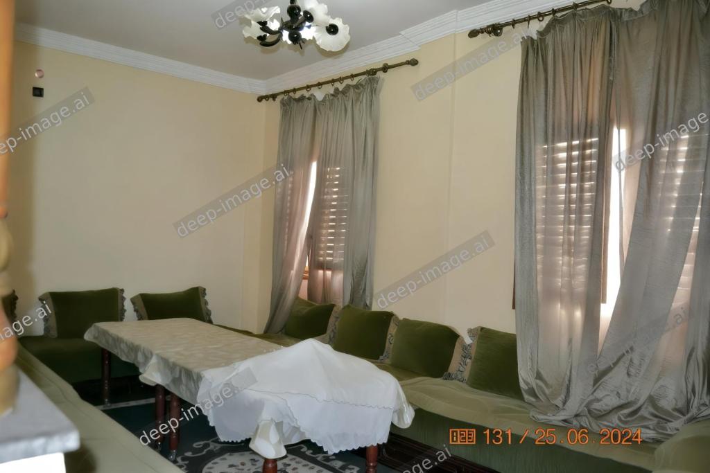 a hospital room with a couch and windows at Appartement lumineux et spacieux en plein centre ville in Ouarzazate