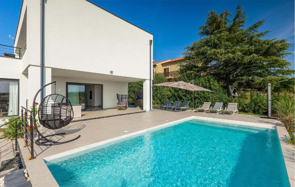 a swimming pool in the backyard of a house at Villa Auri in Pula