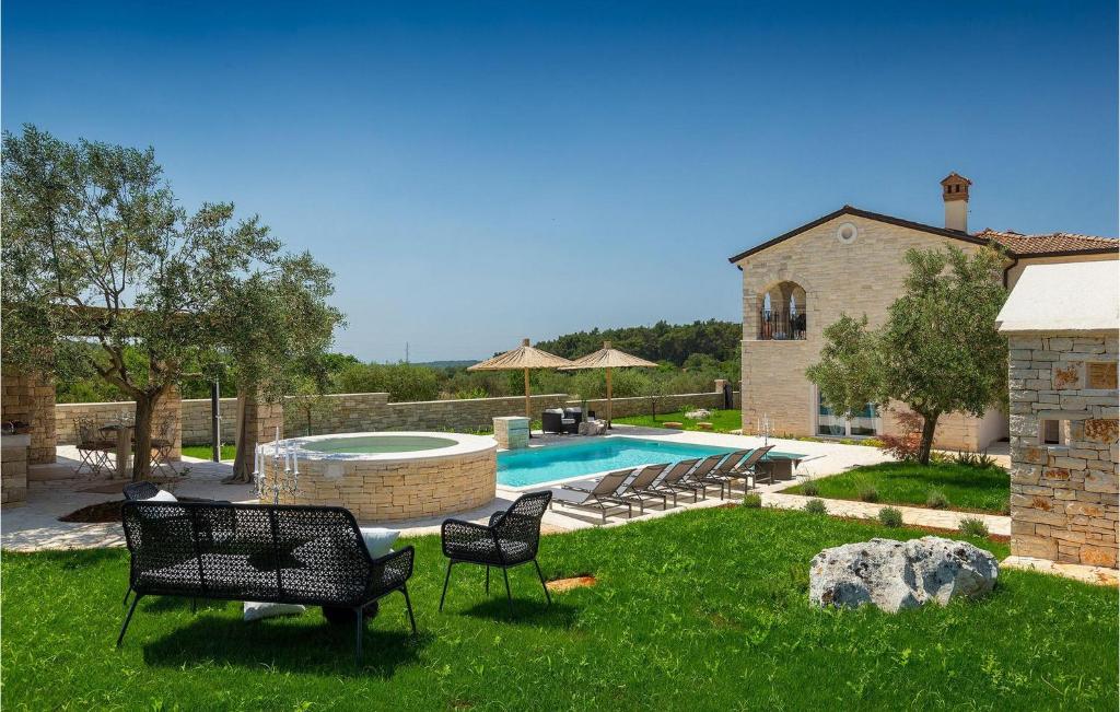 a yard with two chairs and a swimming pool at Villa Piccolo Paradiso in Rovinj