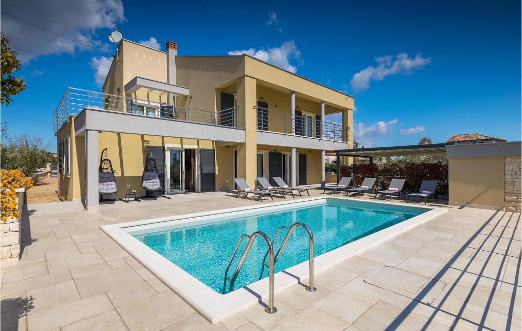 a villa with a swimming pool in front of a house at Villa Bursic in Pula