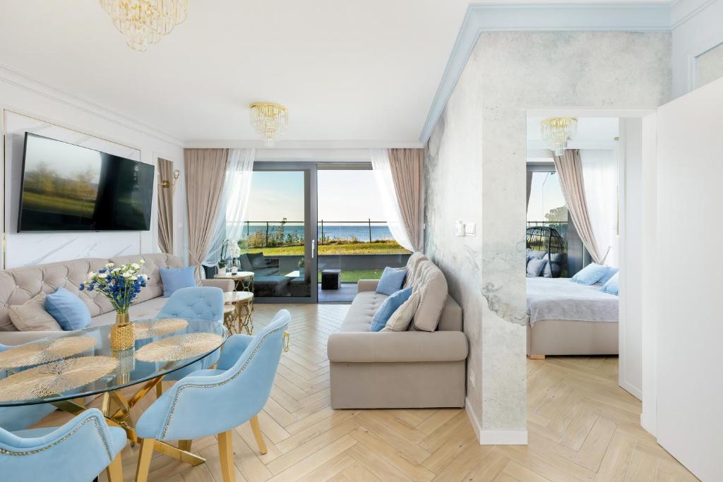 a living room with a couch and a table at Apartament Holiday Gold in Rewal