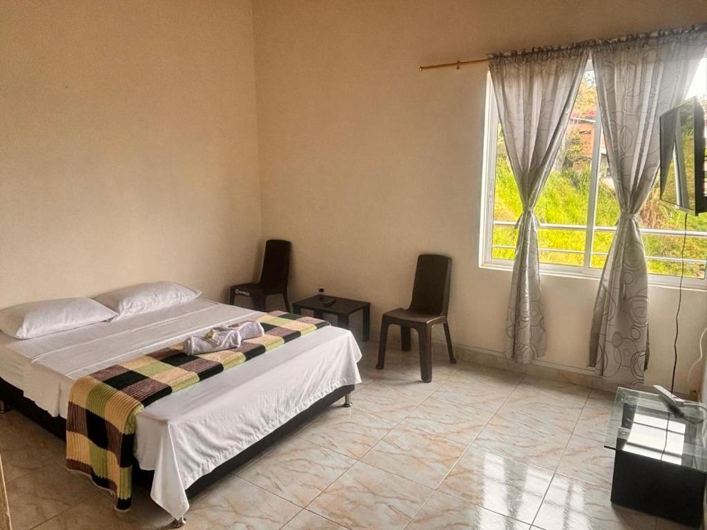 Postel nebo postele na pokoji v ubytování HOSPEDAJE VILLA SAMARA