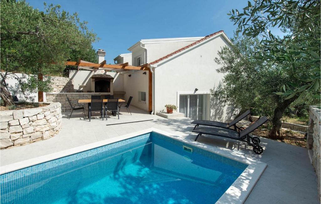 a villa with a swimming pool and a house at Villa Olive Tree Pisak in Pisak