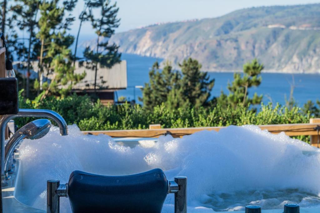 a tub filled with water with a chair in it at Vista Hermosa Laguna Verde in Laguna Verde