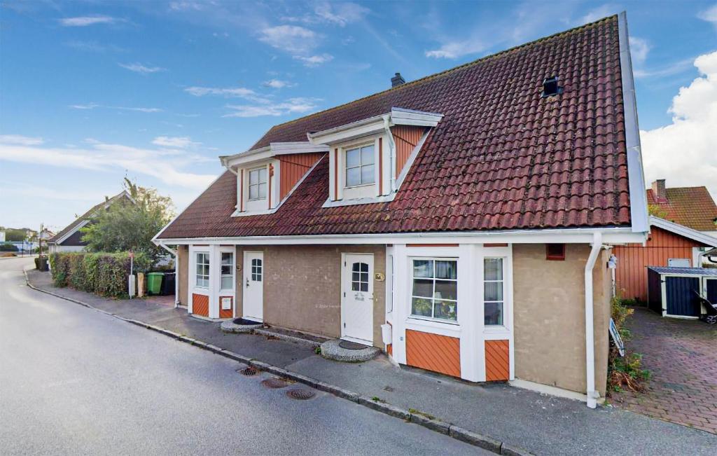 a house with a red roof on a street at Beautiful Home In Höganäs With Wifi in Höganäs
