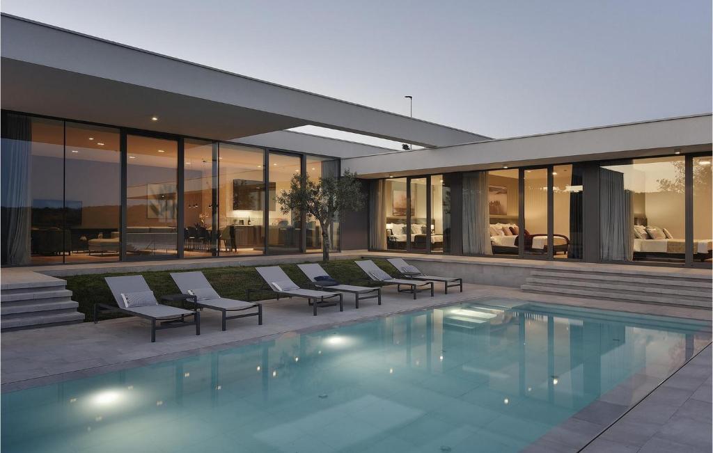 a house with a swimming pool in front of it at Villa Kalipso in Nova Vas