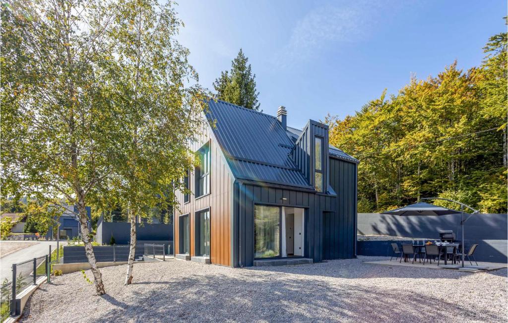 a contemporary house with a black roof at Awesome Home In Stari Laz With Kitchen in Stari Laz