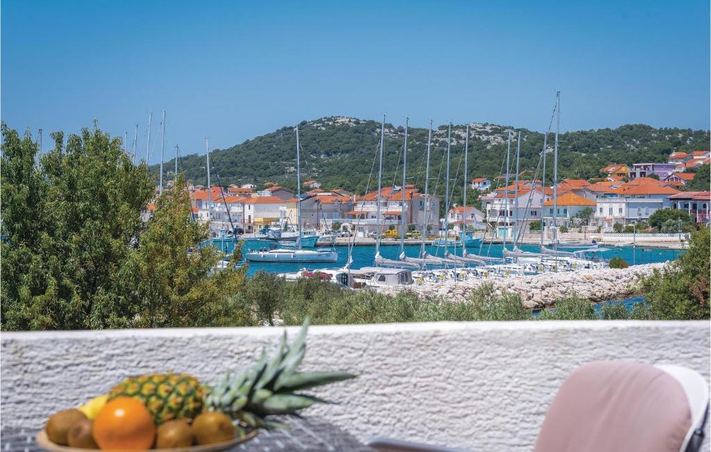 a plate of fruit on a table with a marina at One-Bedroom Apartment In Jezera in Jezera