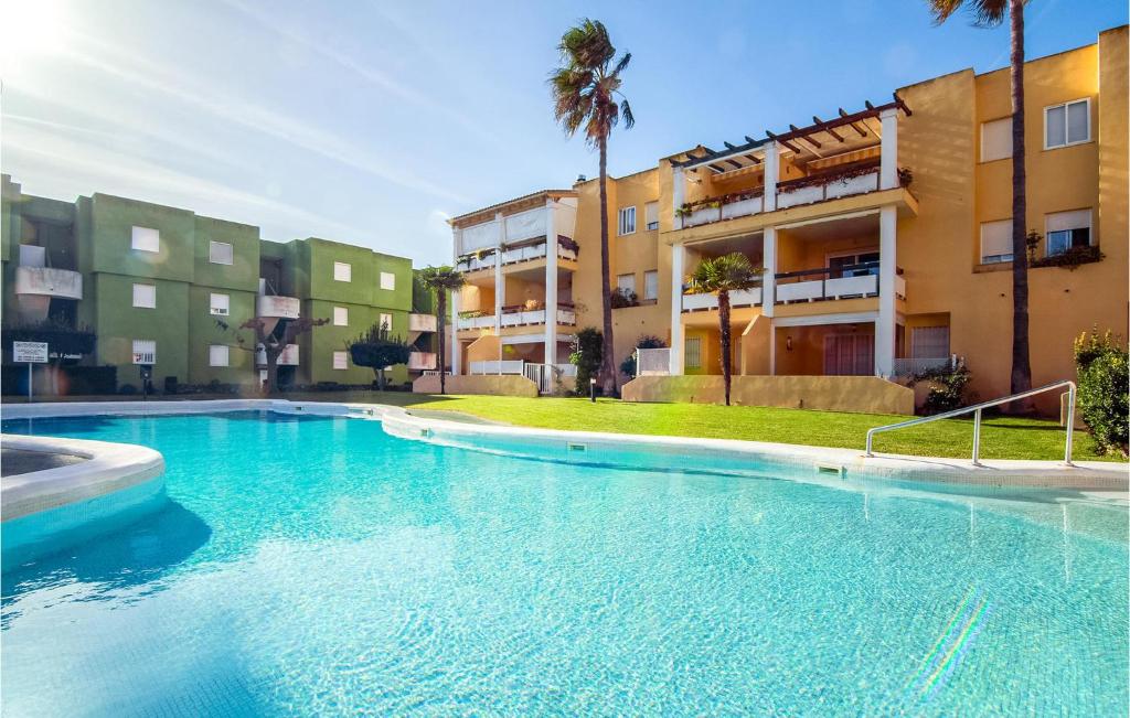 a large swimming pool in front of a building at Nice Apartment In Xeraco With Wifi in Xeraco