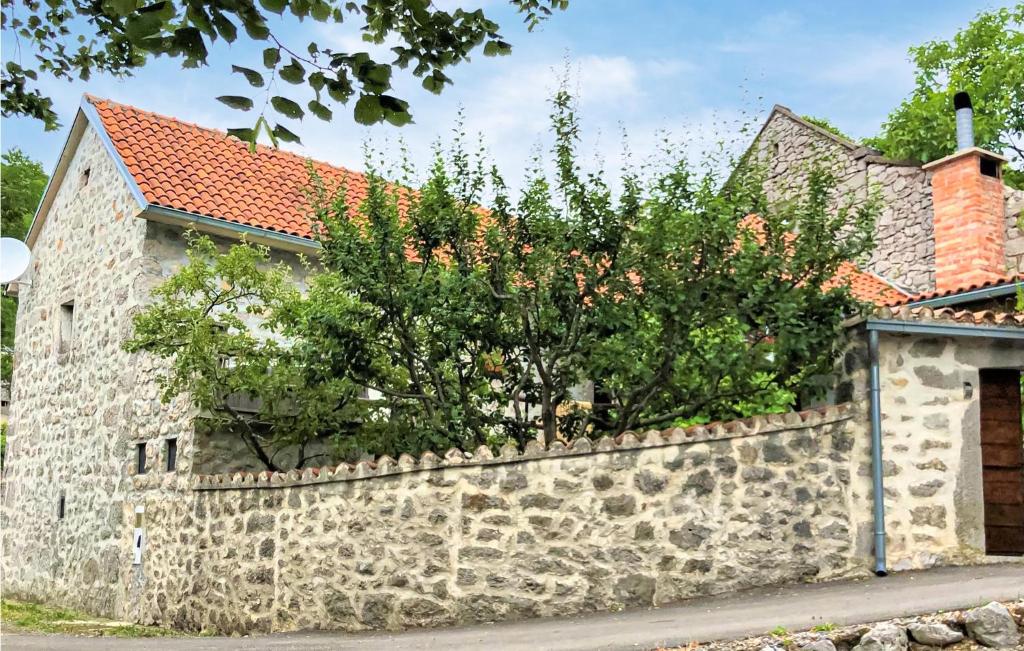 a stone wall in front of a house at Amazing Home In Novi Vinodolski in Novi Vinodolski