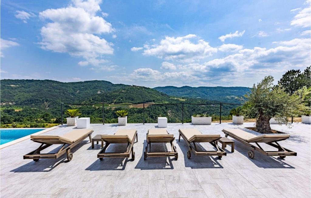 a group of picnic tables and chairs on a patio at Villa Bella Draguc in Draguć