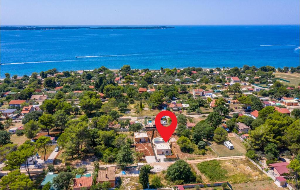 an aerial view of a suburb with a red marker at Awesome Home In Peroj in Peroj